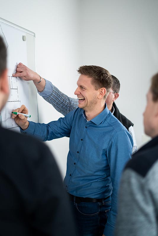 Das Foto zeigt eine Gruppe von Menschen bei einer Besprechung